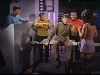 Spock talks to female alien, Kirk and others look on