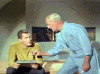 Dr. Phillip Boyce serves Pike a martini